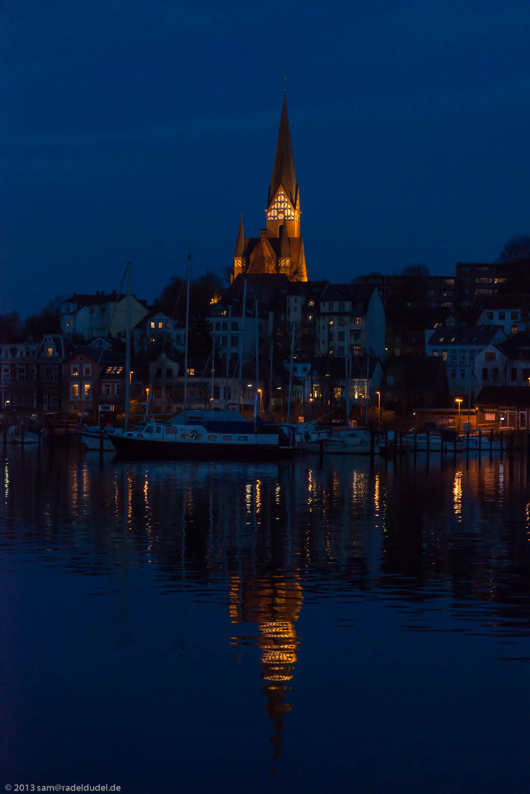 St. Jürgenkirche spiegelt sich Nachts im Flensburger Hafen